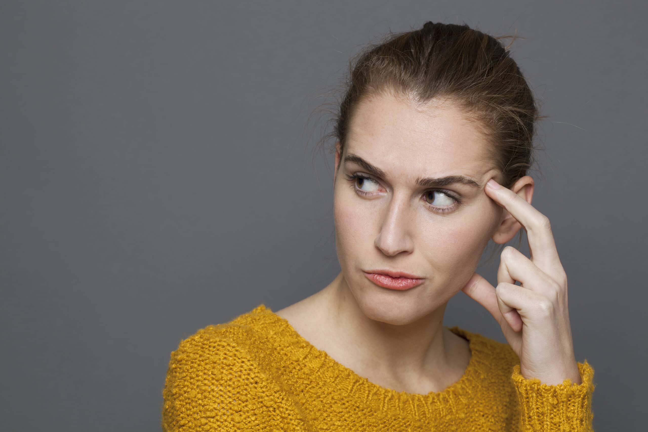 unhappy young woman looking dubious,expressing confusion and mistrust