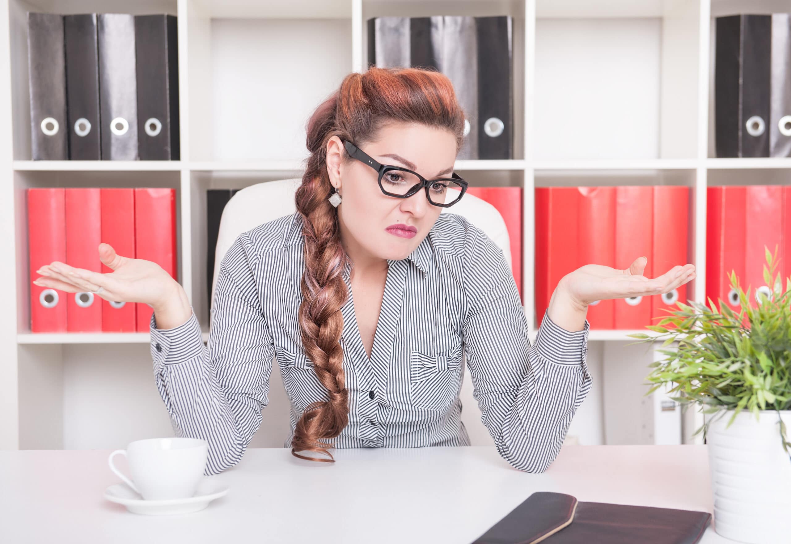 Business woman shrugging her shoulders