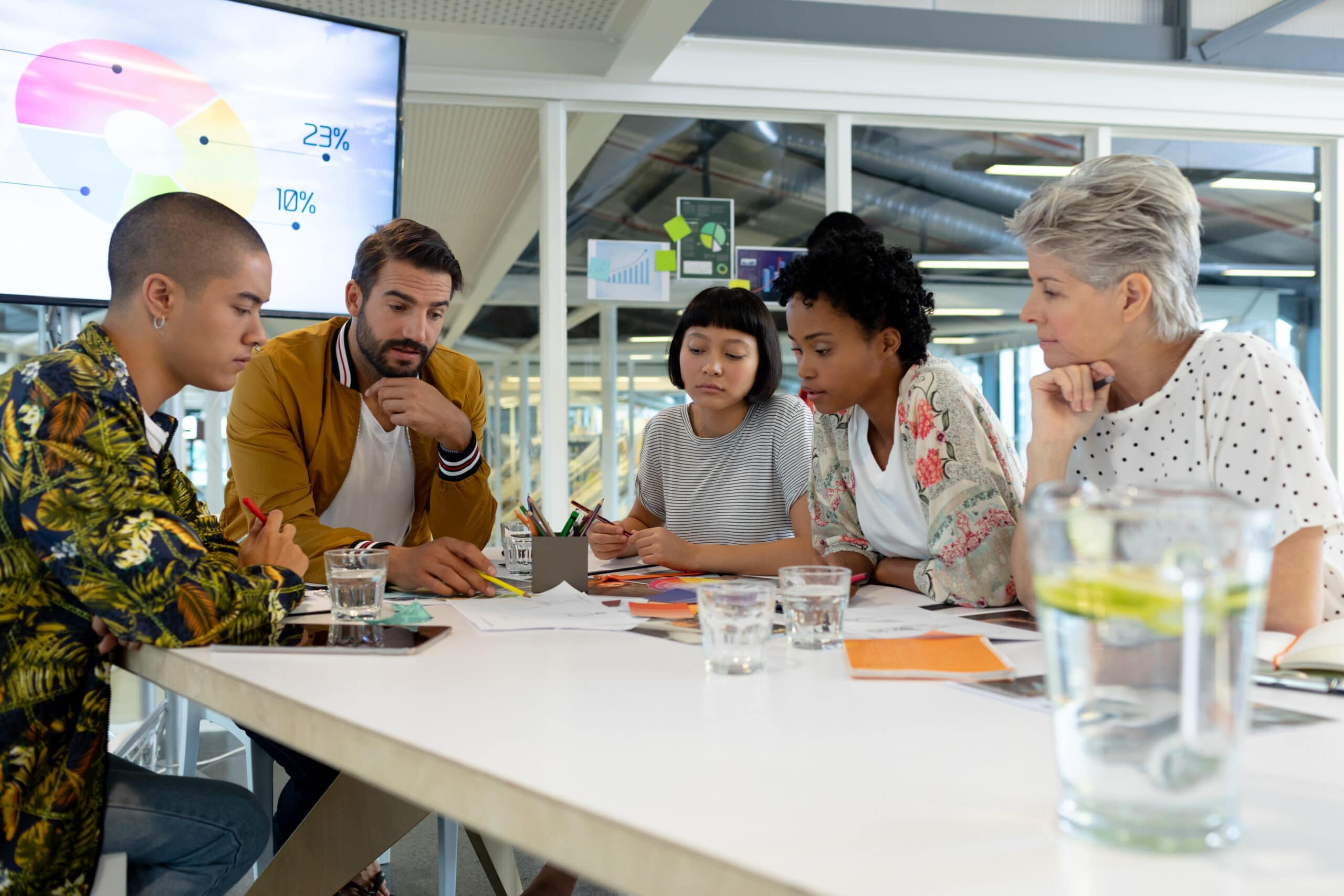 Side view of diverse business people discussing in the meeting at conference room in office