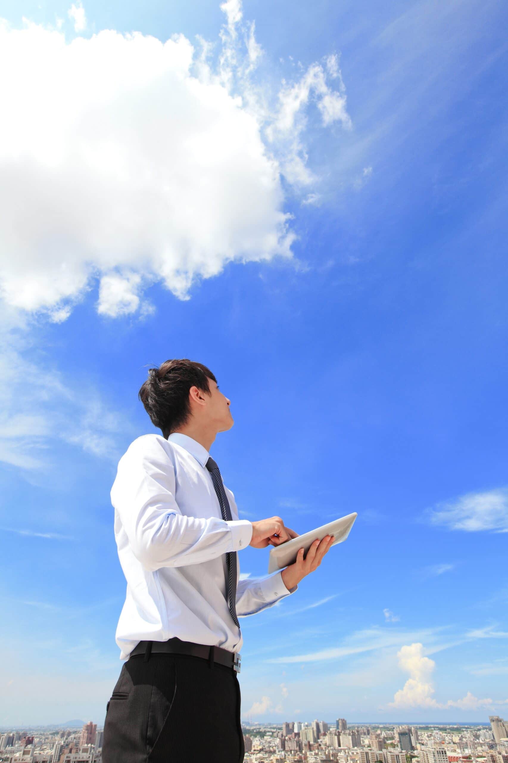 young business man using tablet pc and look to blue sky