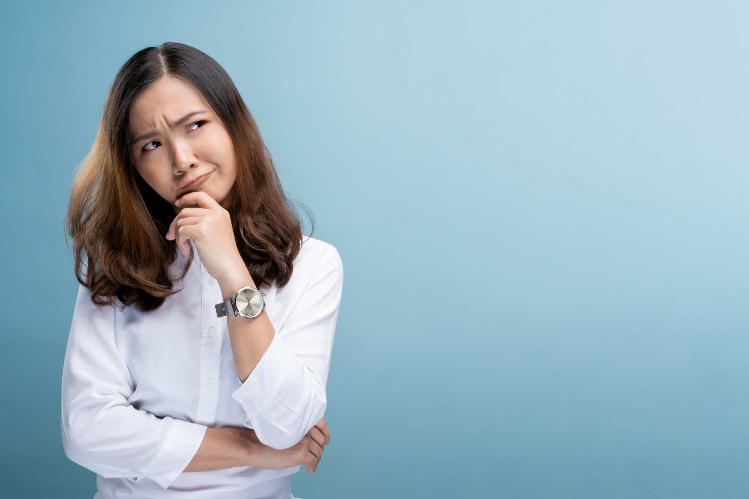 Woman feel confused isolated over blue background