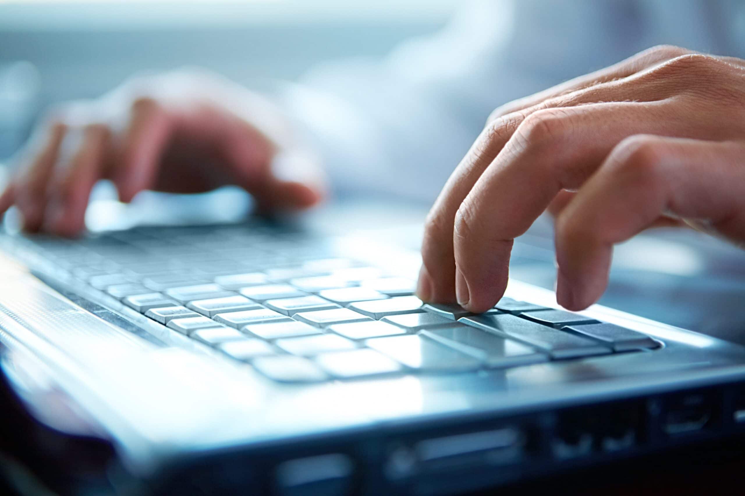 Close-up of typing male hands